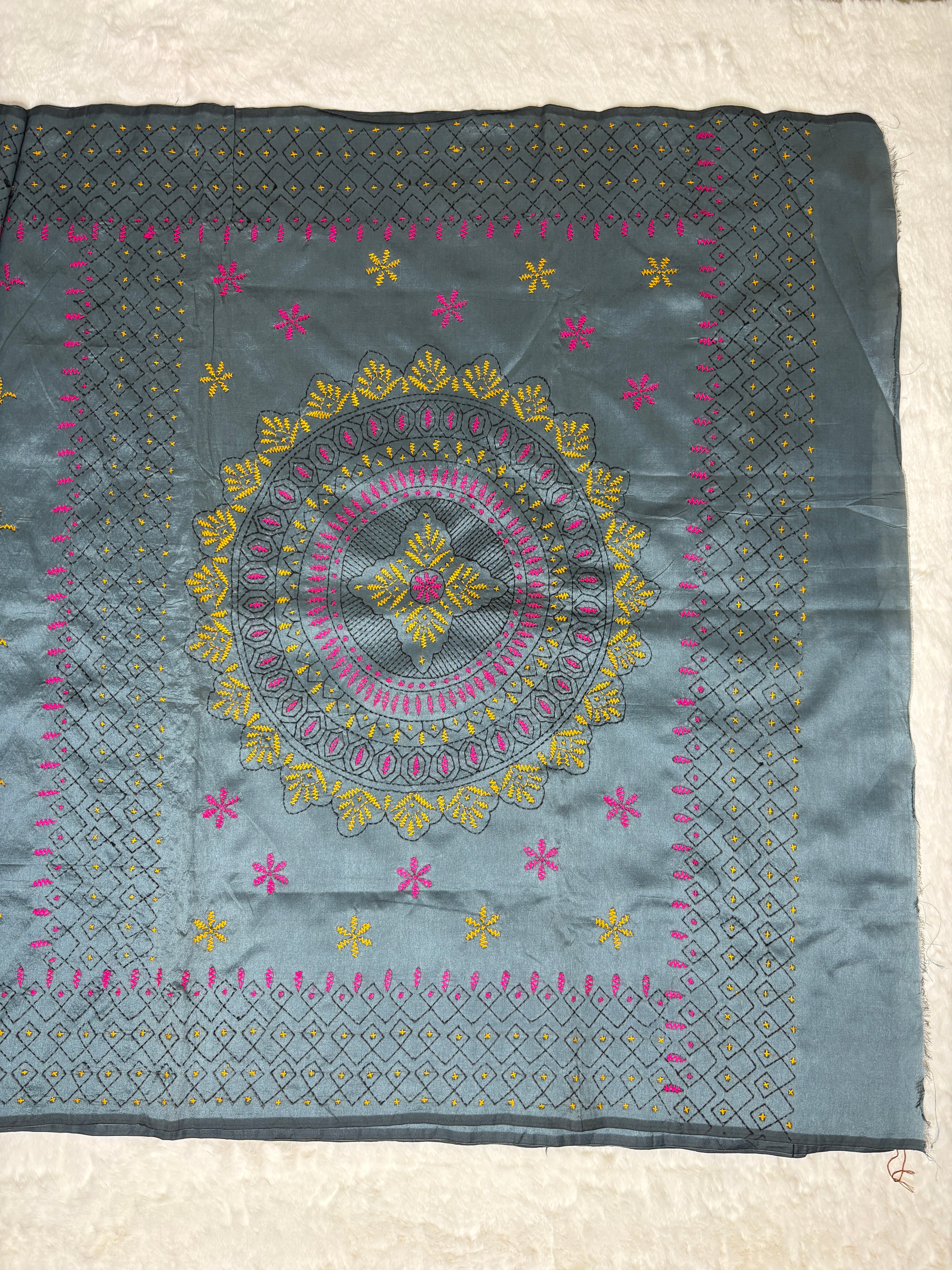 Embroidered fabric with floral patterns on a white background