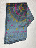 Embroidered fabric with floral patterns on a white background