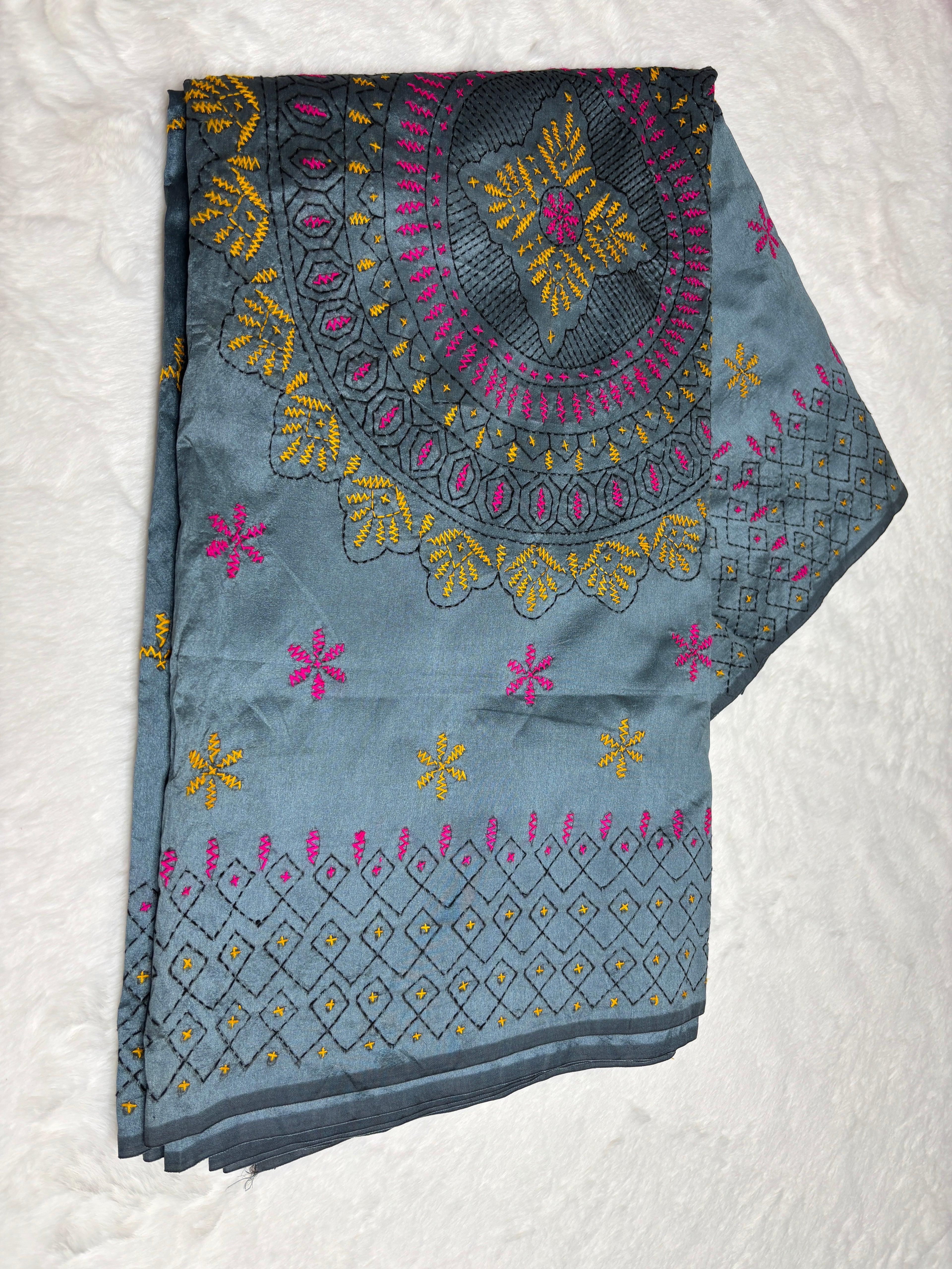 Embroidered fabric with floral patterns on a white background