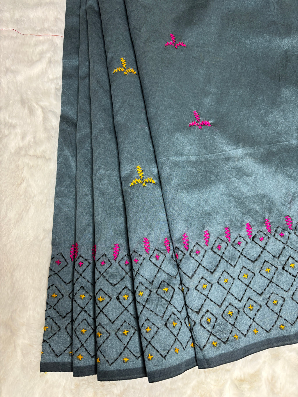 Embroidered fabric with floral patterns on a white background