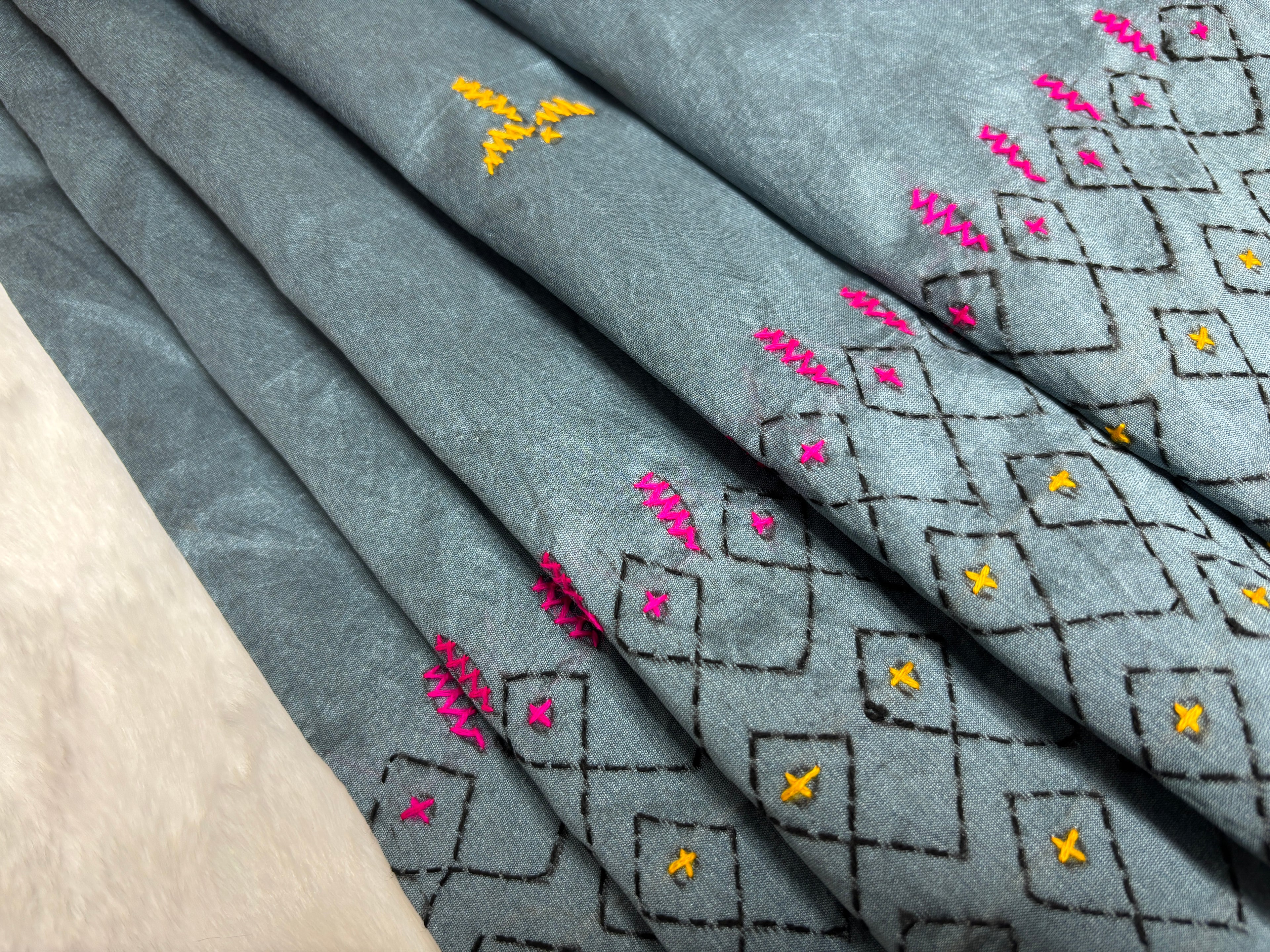 Embroidered fabric with floral patterns on a white background