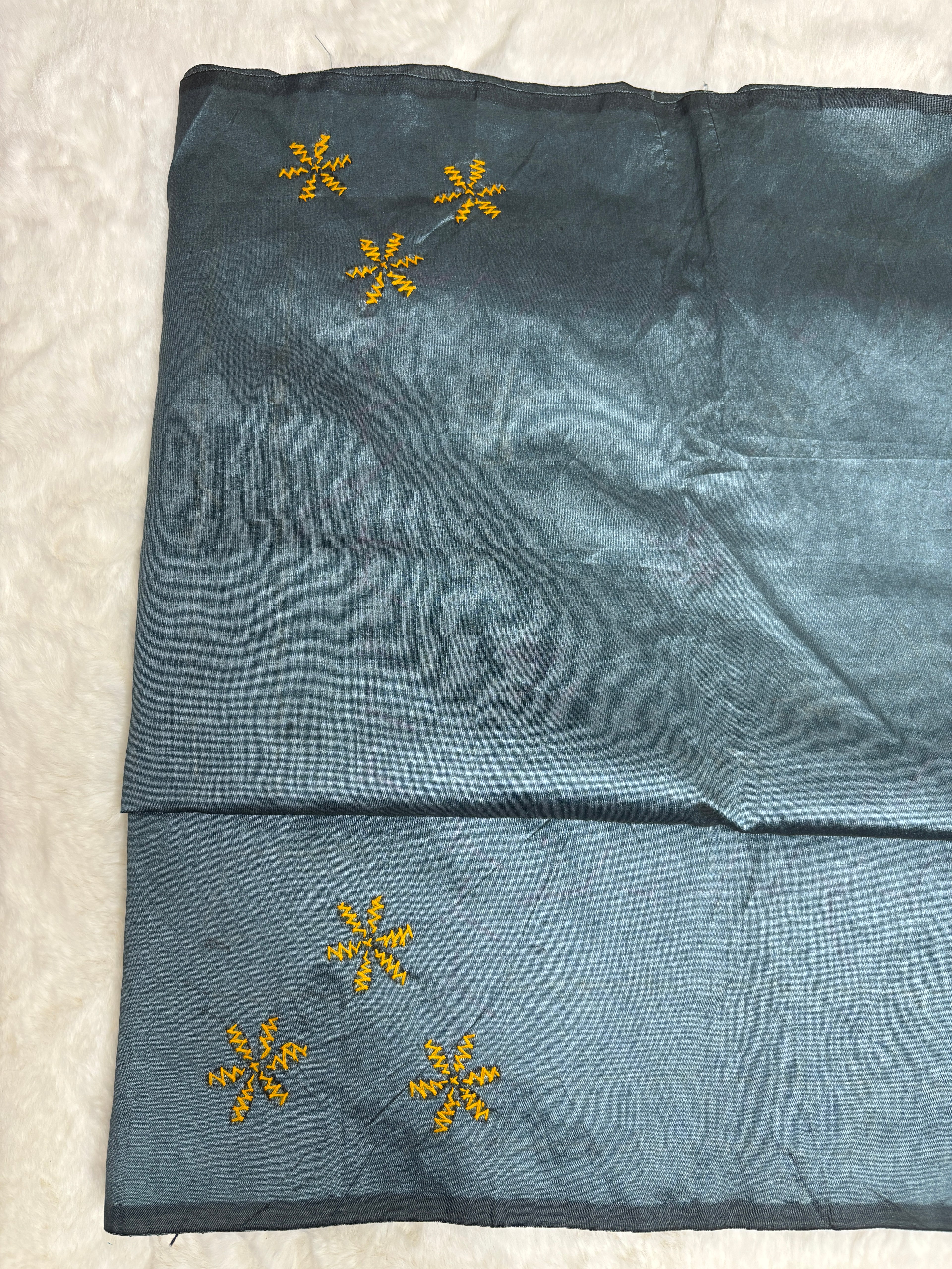 Embroidered fabric with floral patterns on a white background
