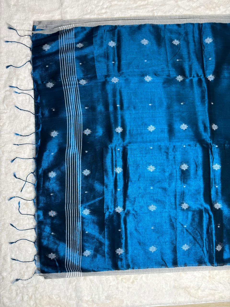 Blue fabric with white patterns on a light gray background