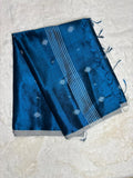 Blue fabric with white patterns on a light gray background