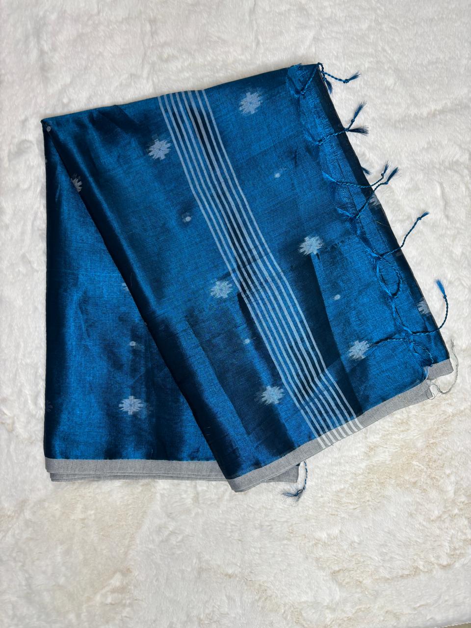 Blue fabric with white patterns on a light gray background