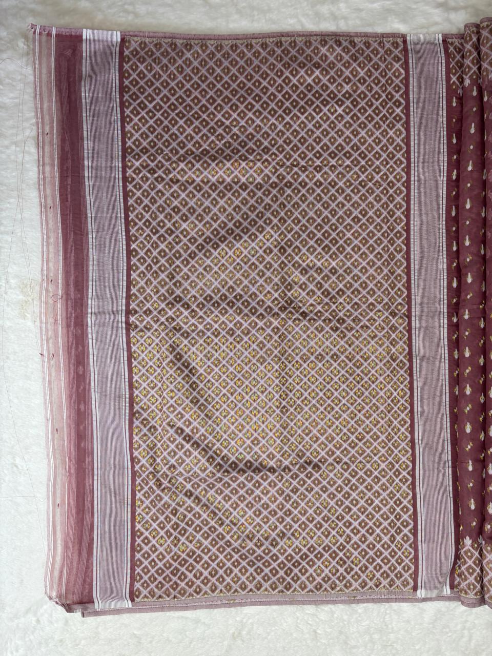 Patterned fabric with maroon and beige colors on a white background
