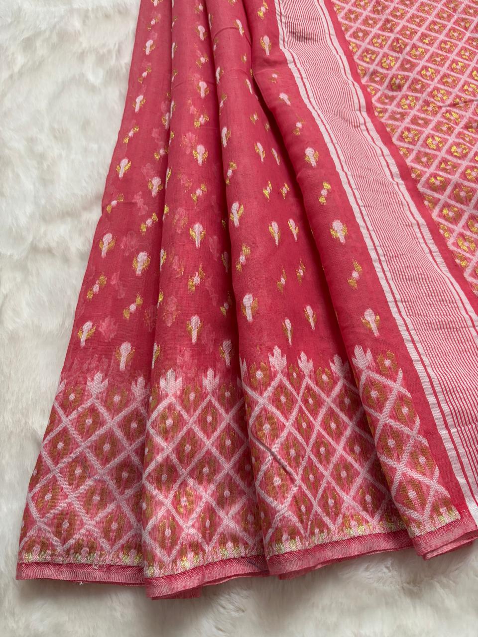 Pink saree with intricate patterns on a light gray background