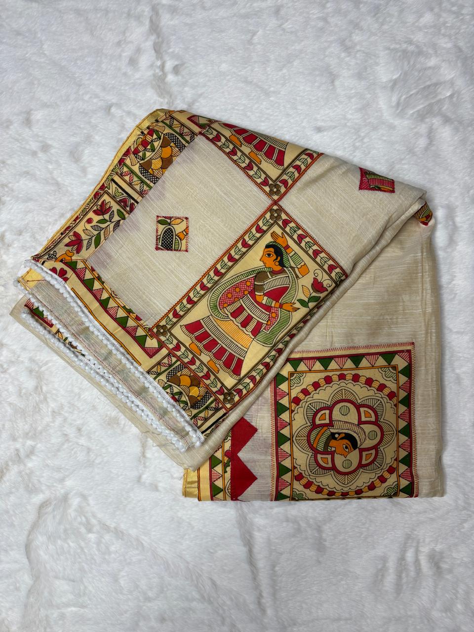 Folded fabric with intricate patterns on a textured white surface