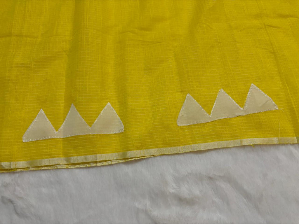 Yellow fabric with white mountain-like patterns on a white background