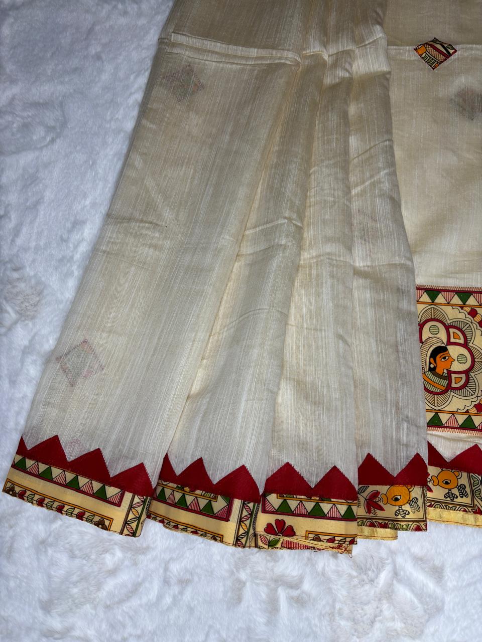 Traditional saree with a decorative border on a textured surface