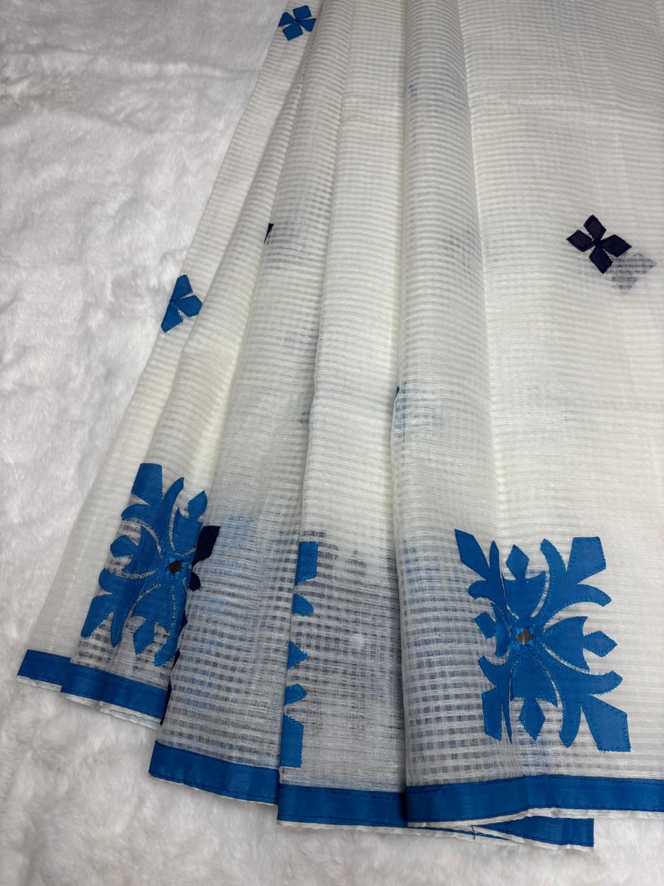 White fabric with blue floral patterns on a textured surface