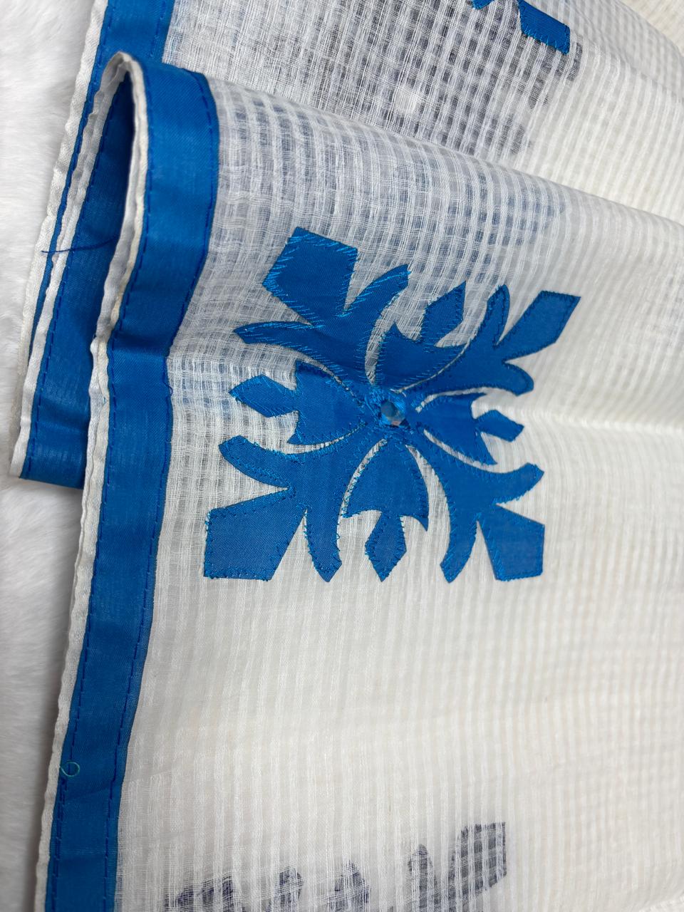 White fabric with blue floral design on a white background