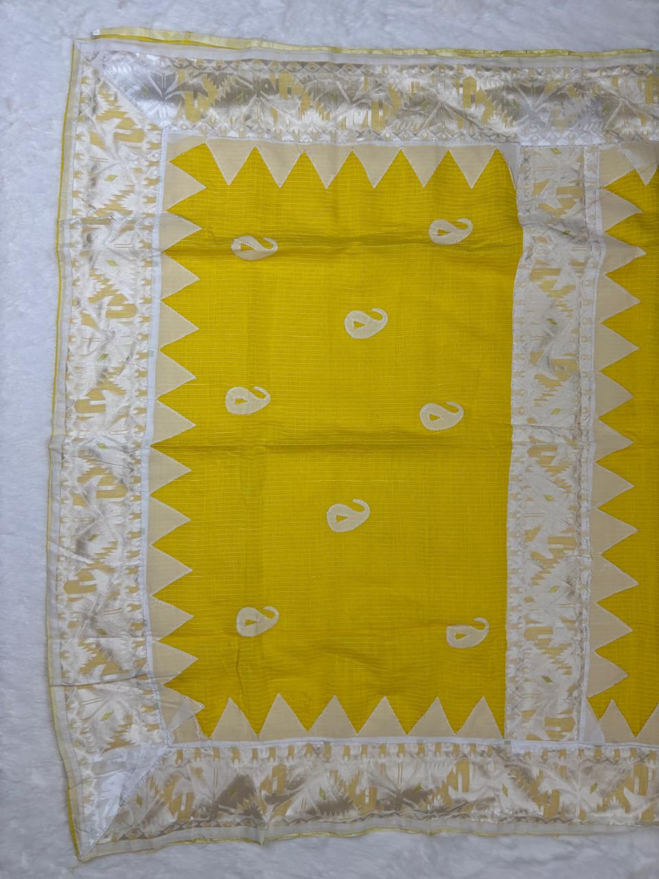 Yellow fabric with white patterns on a white background