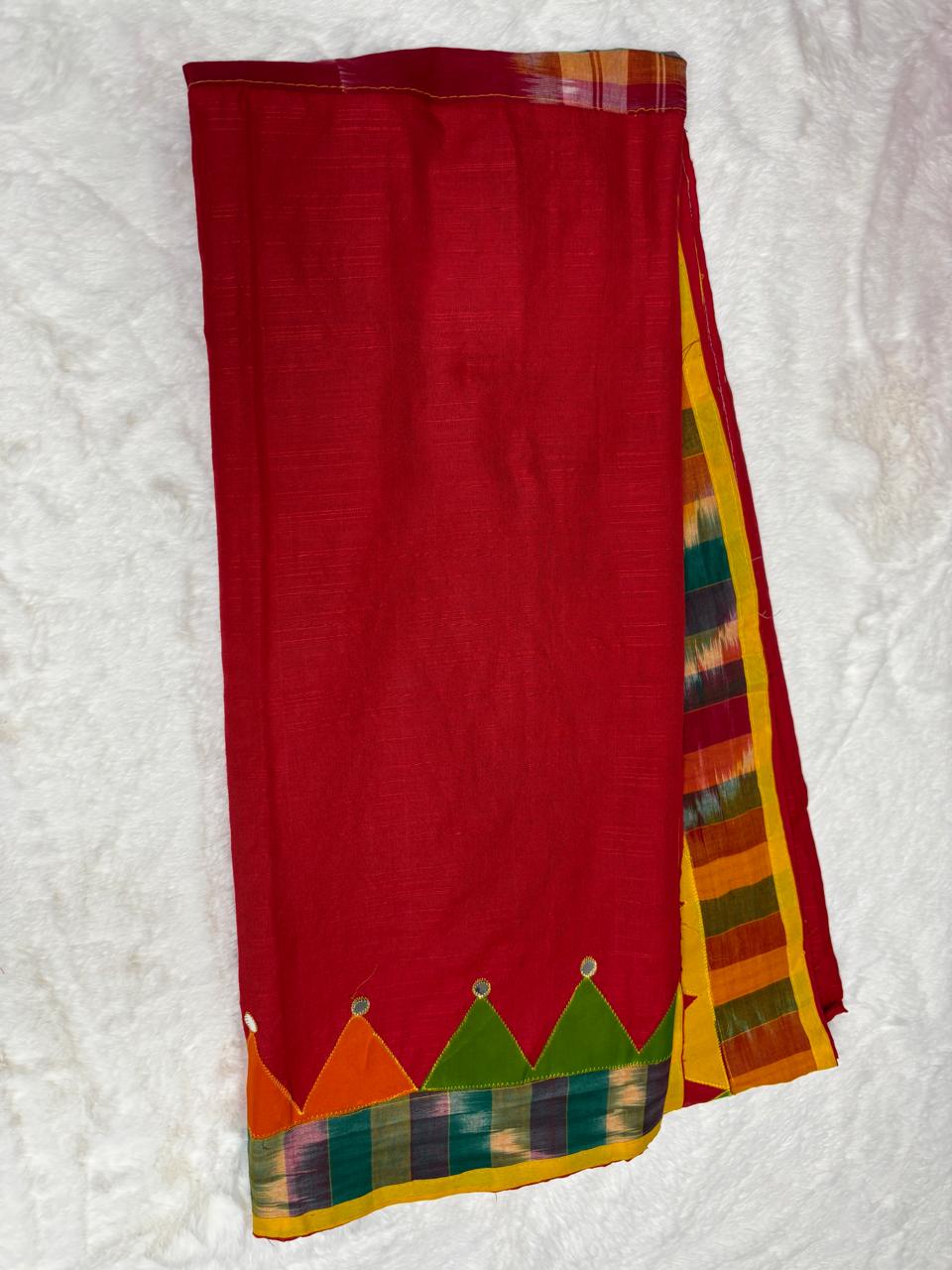 Red saree with colorful border on a white background