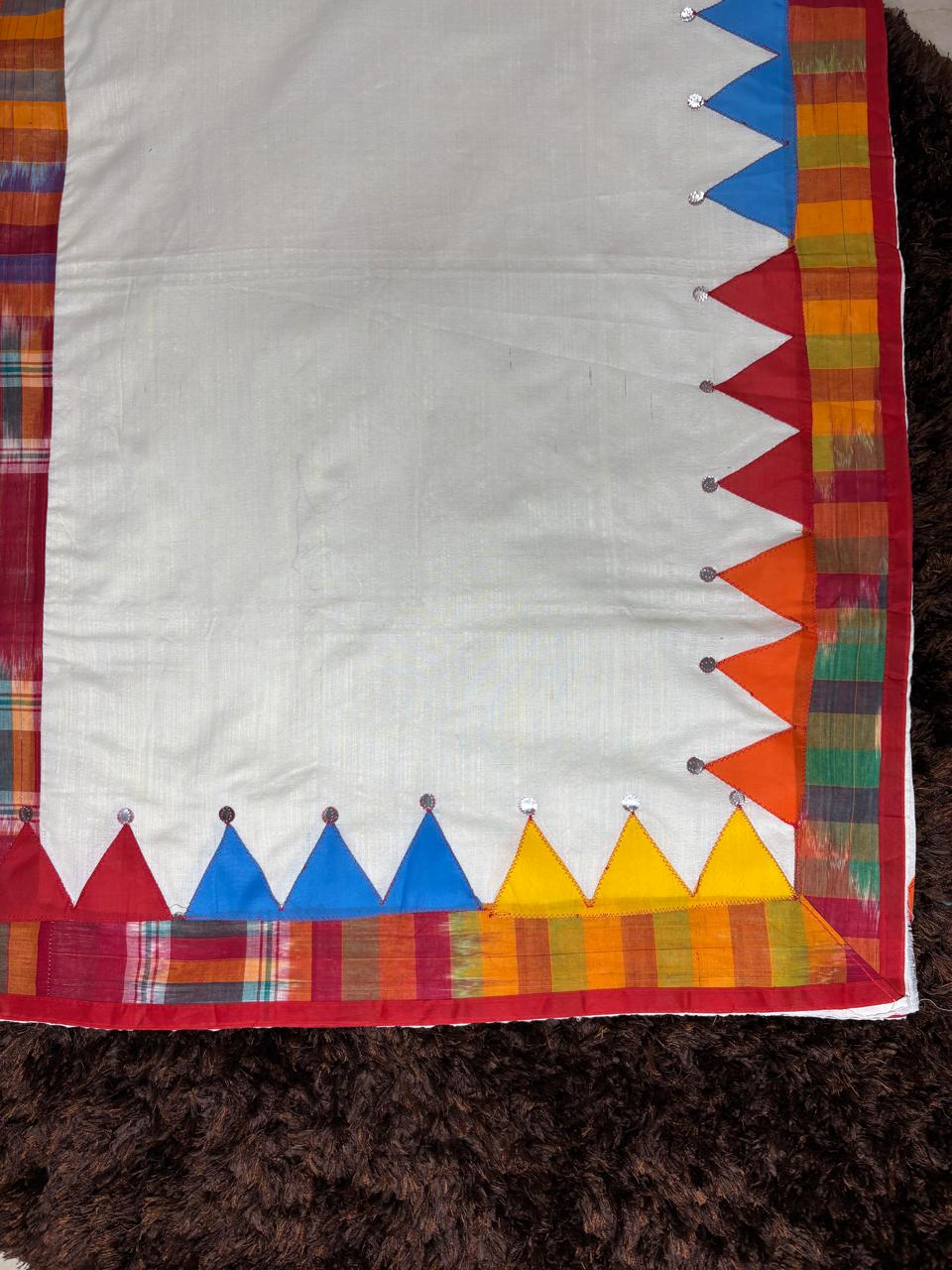 Colorful fabric border with geometric patterns on a plain background