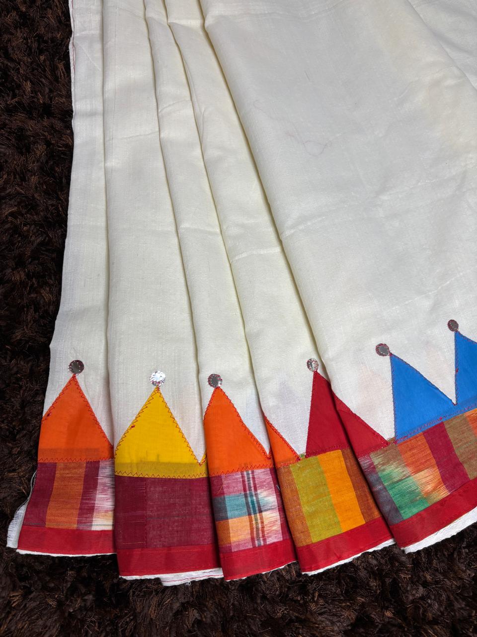 White fabric with colorful triangular patterns on a dark background