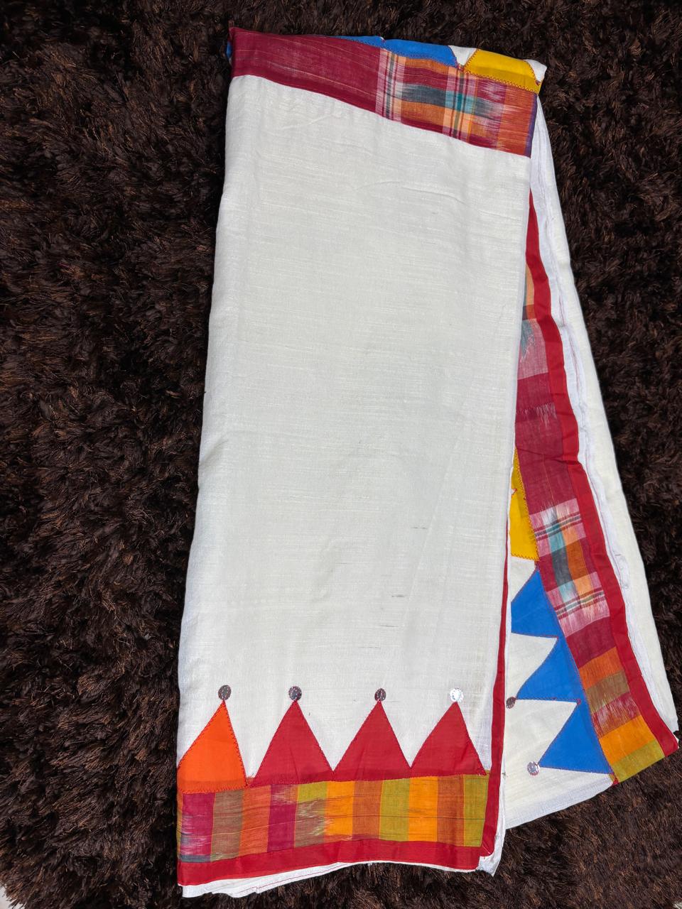 Colorful traditional fabric with geometric patterns on a brown textured background