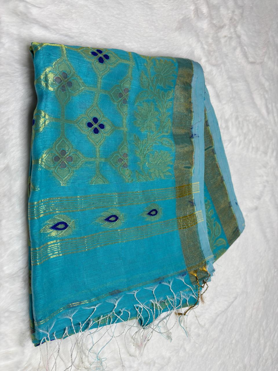 Blue and green patterned fabric with fringe on a white background