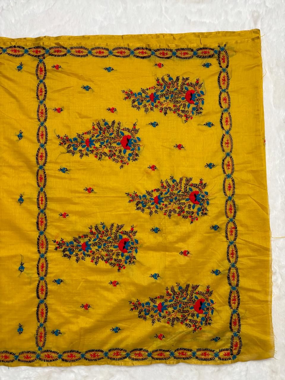 Yellow fabric with floral embroidery on a white background